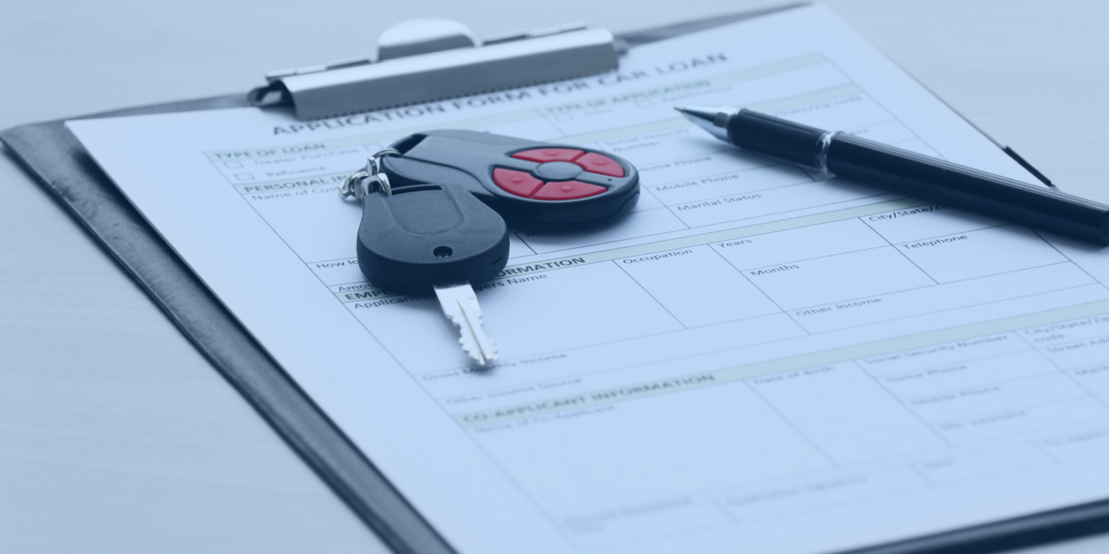 clipboard with keys and a pen